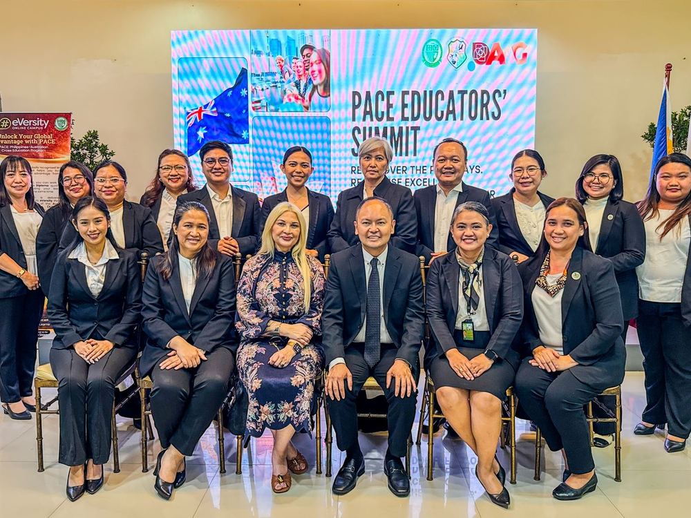 Educators and guests on stage at the PACE Educators&rsquo; Summit beneath the Philippine and Australian flags